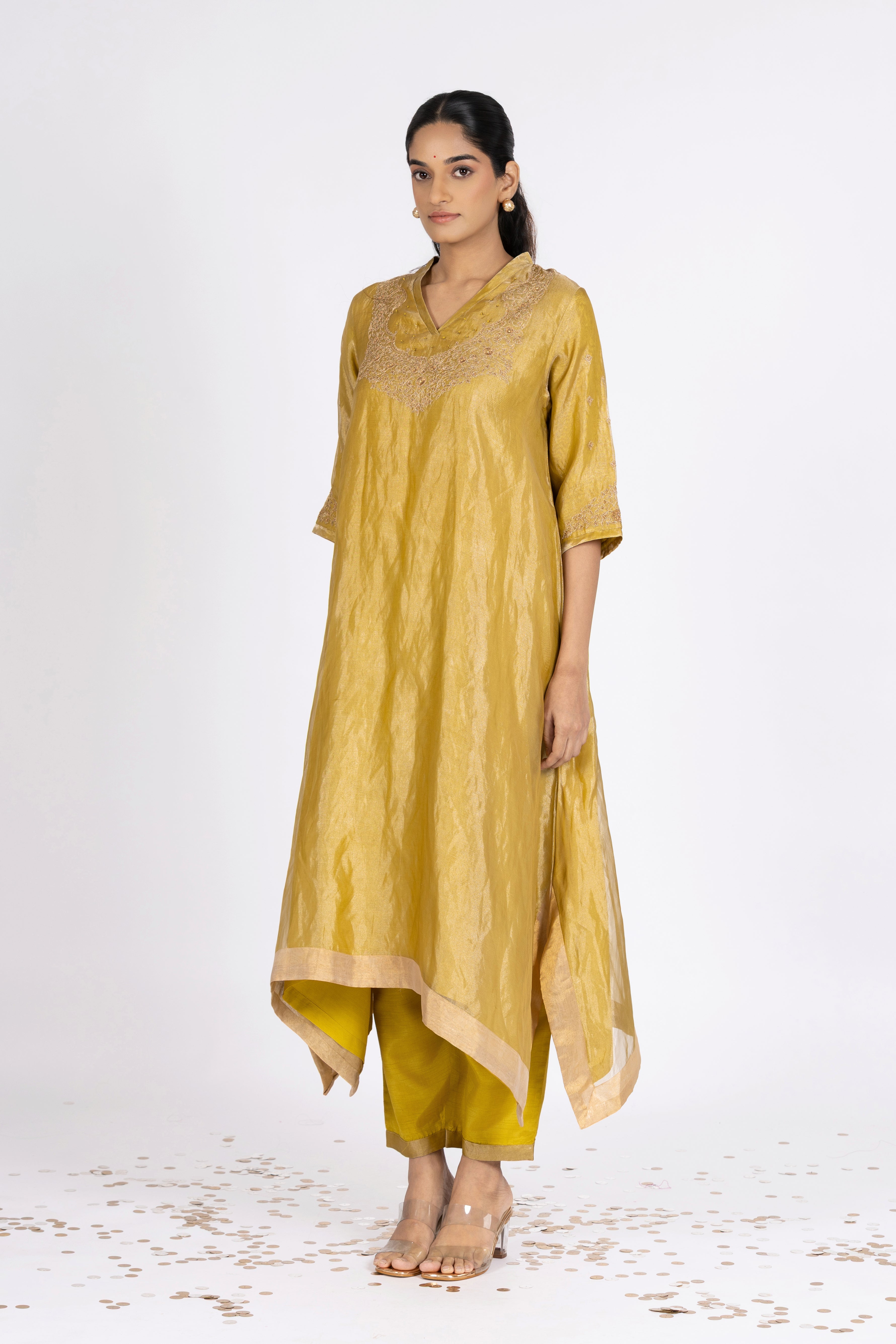 Woman wearing a Green Tissue kurta with gold embroidery on a white background