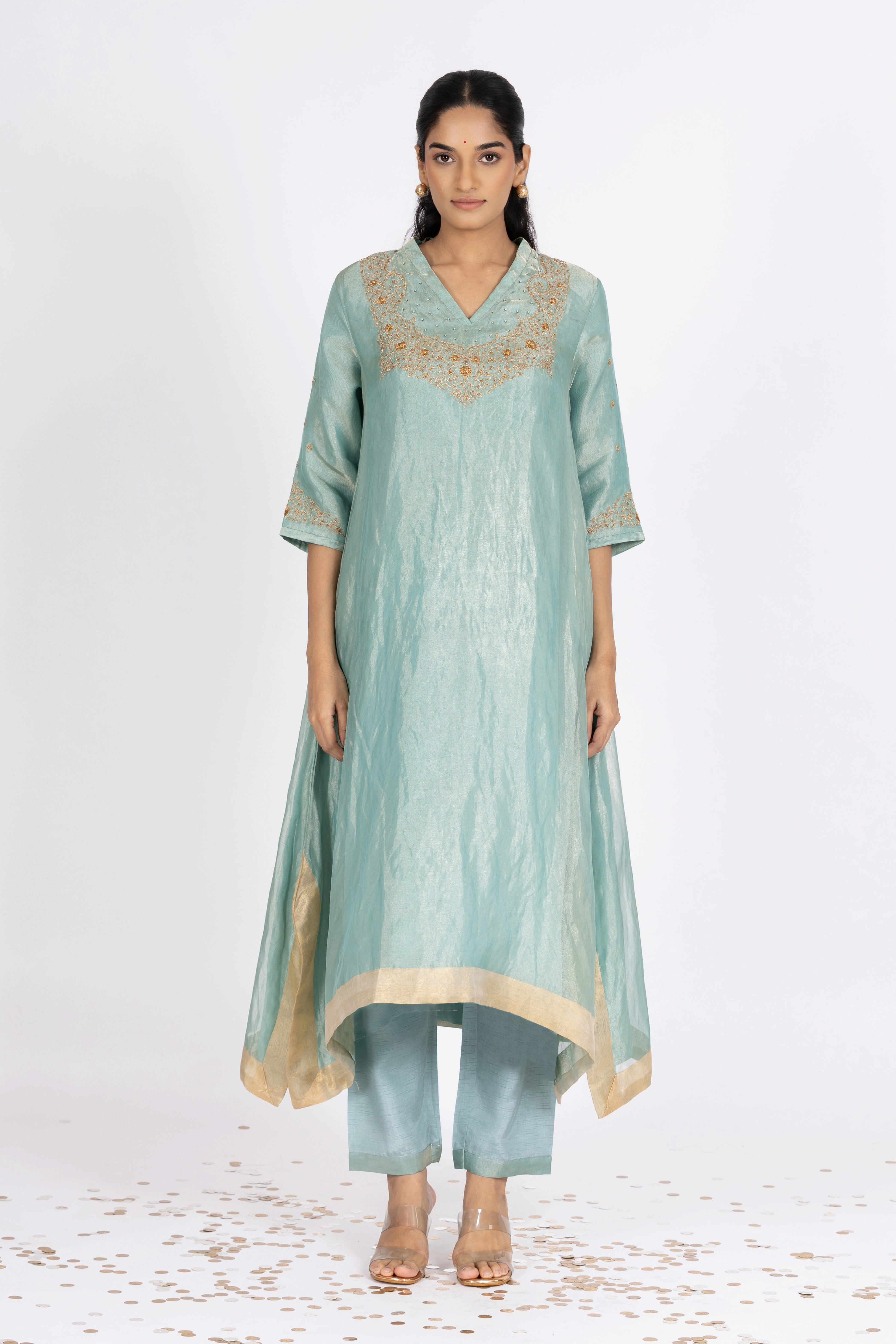 Woman wearing a blue Tissue kurta with gold embroidery on a white background