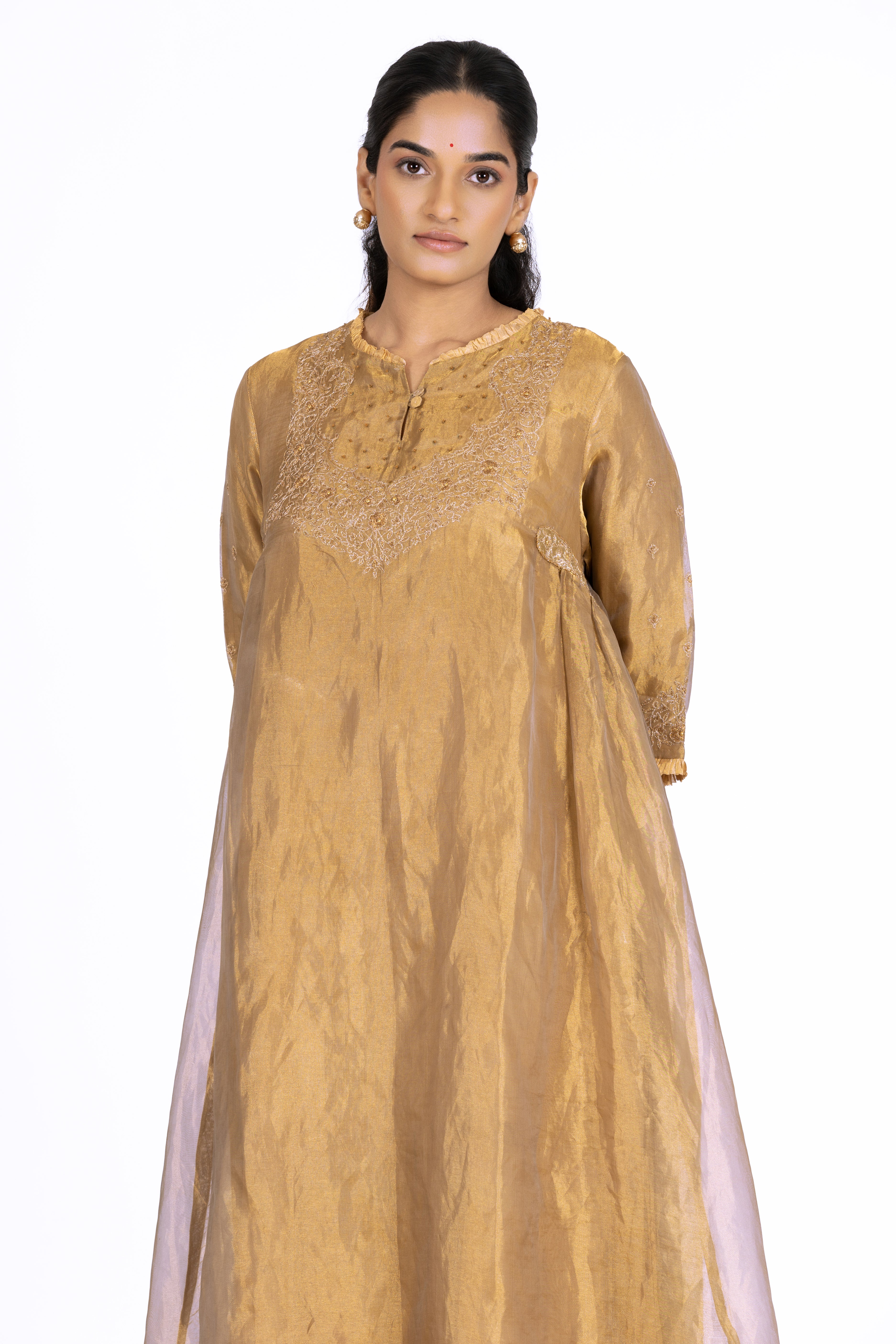 Woman wearing a Golden Tissue kurta with gold embroidery on a white background