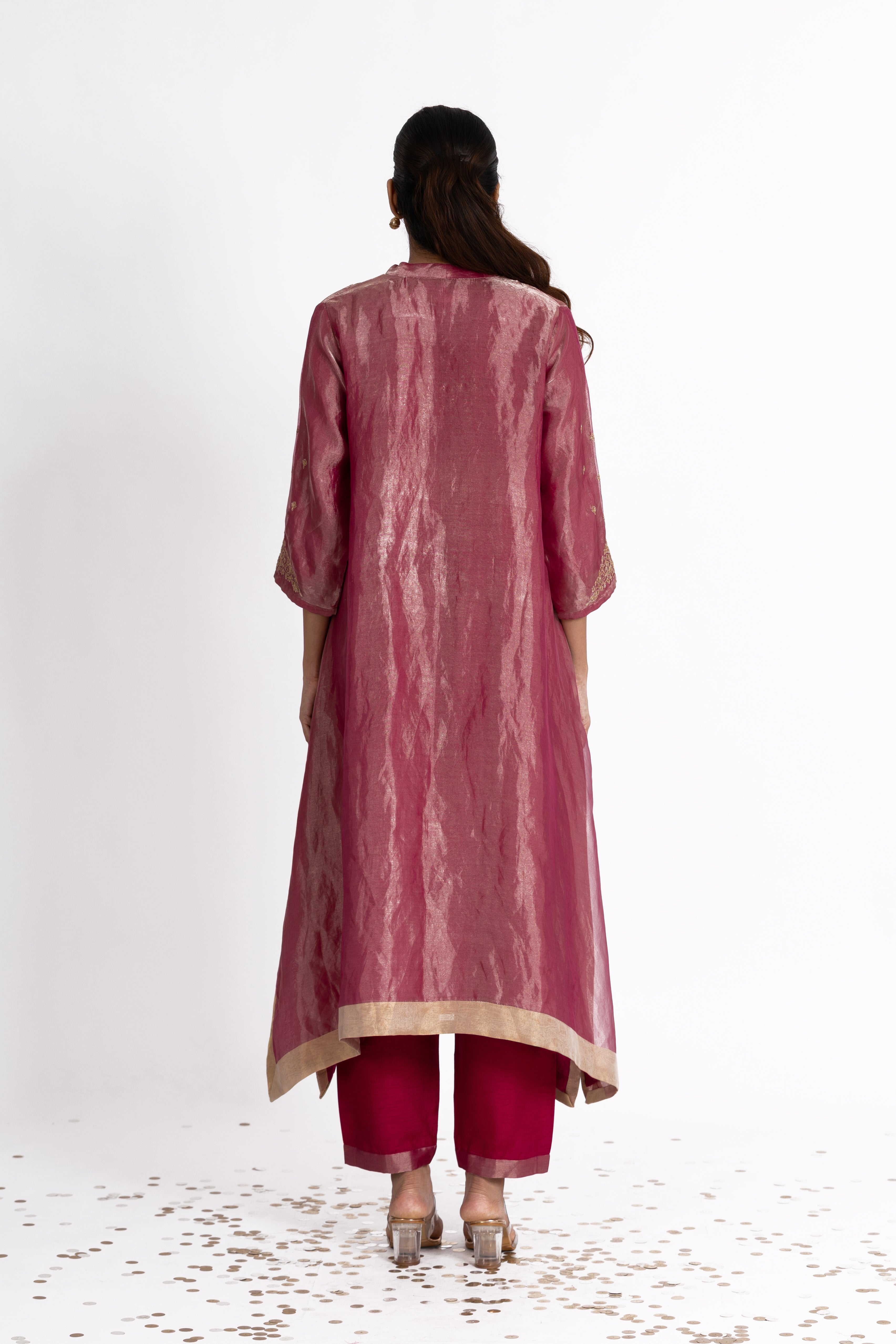 Woman wearing a Pink Tissue kurta with gold embroidery on a white background
