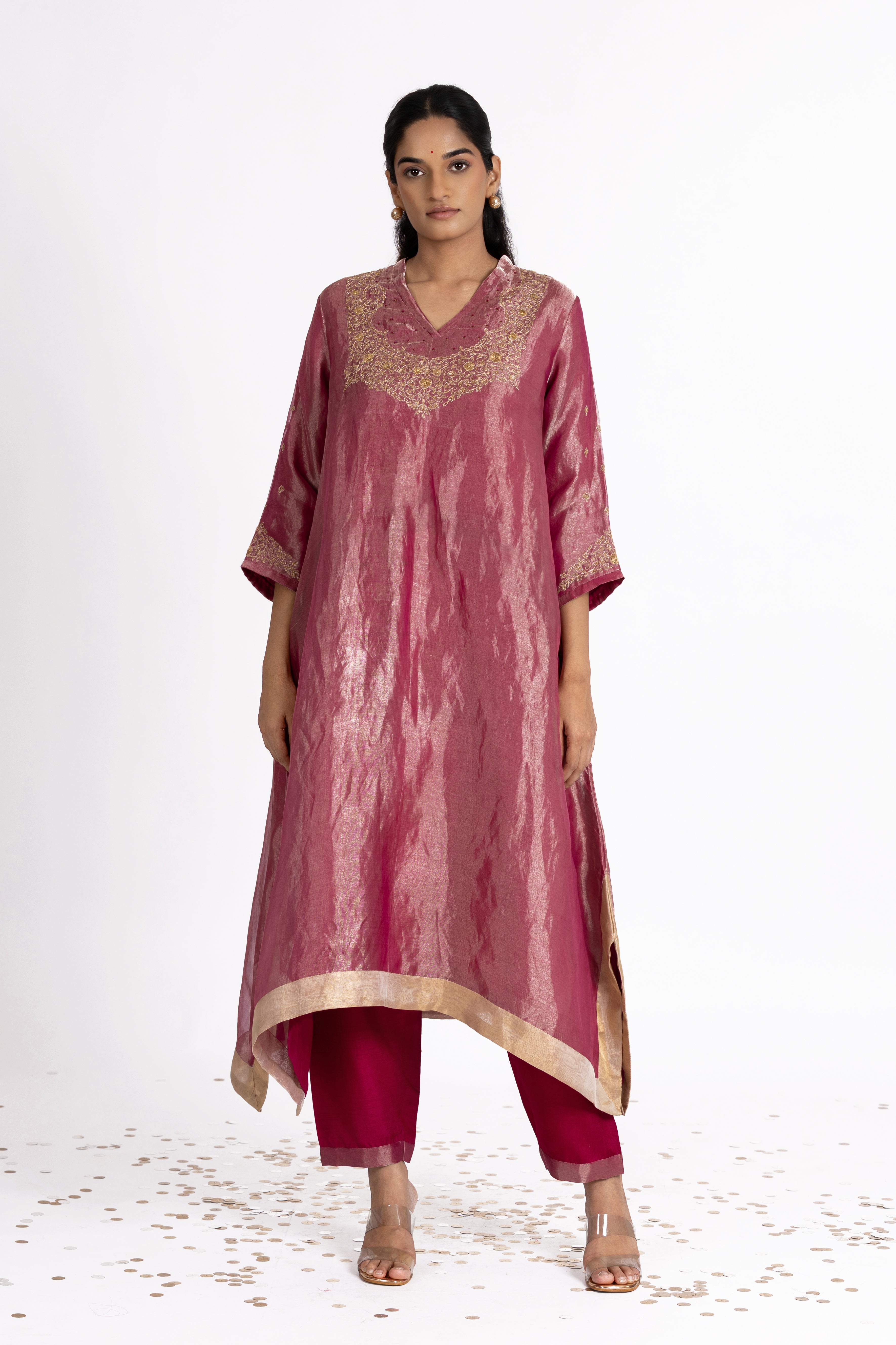 Woman wearing a Pink Tissue kurta with gold embroidery on a white background