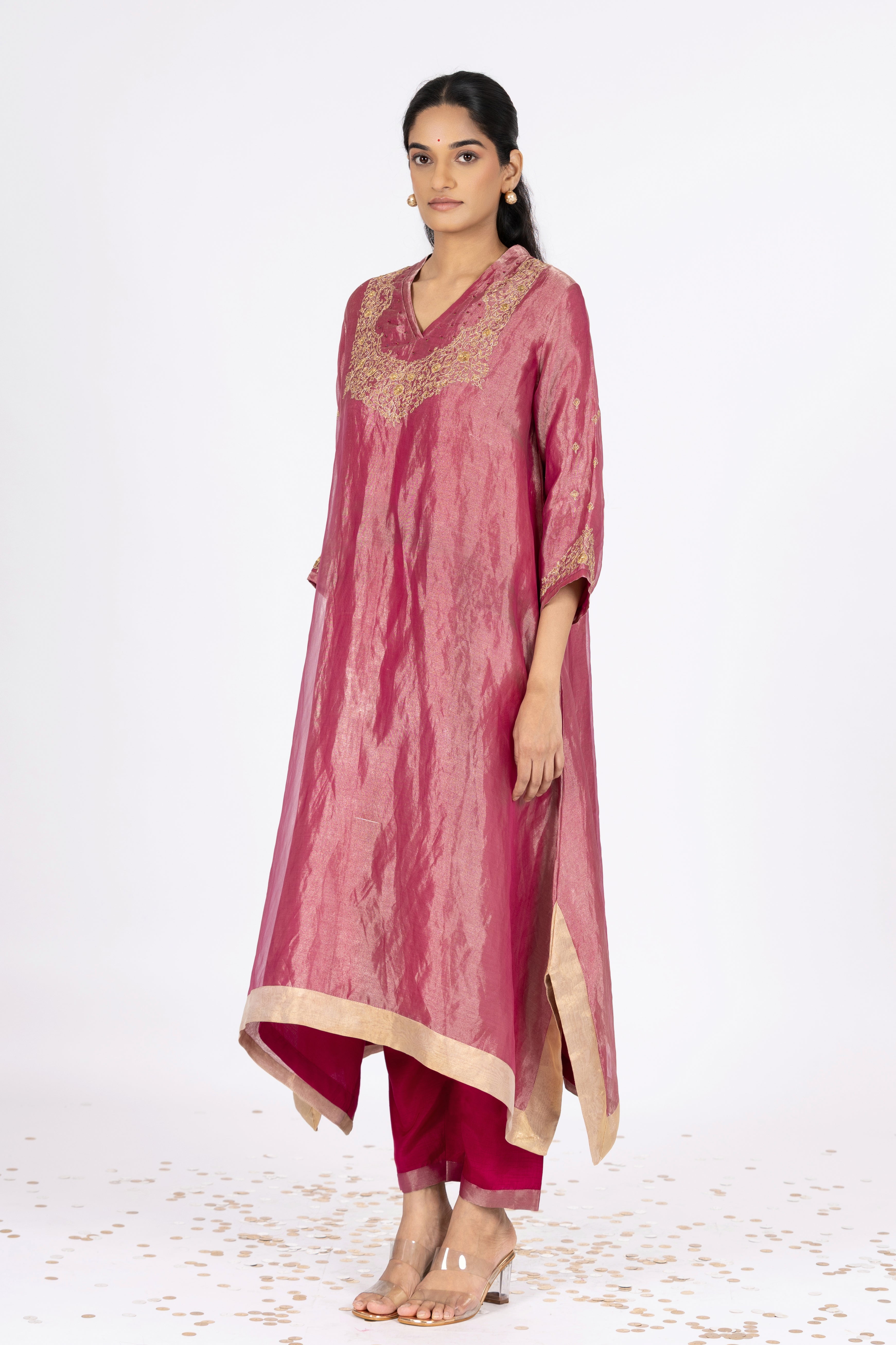 Woman wearing a Pink Tissue kurta with gold embroidery on a white background