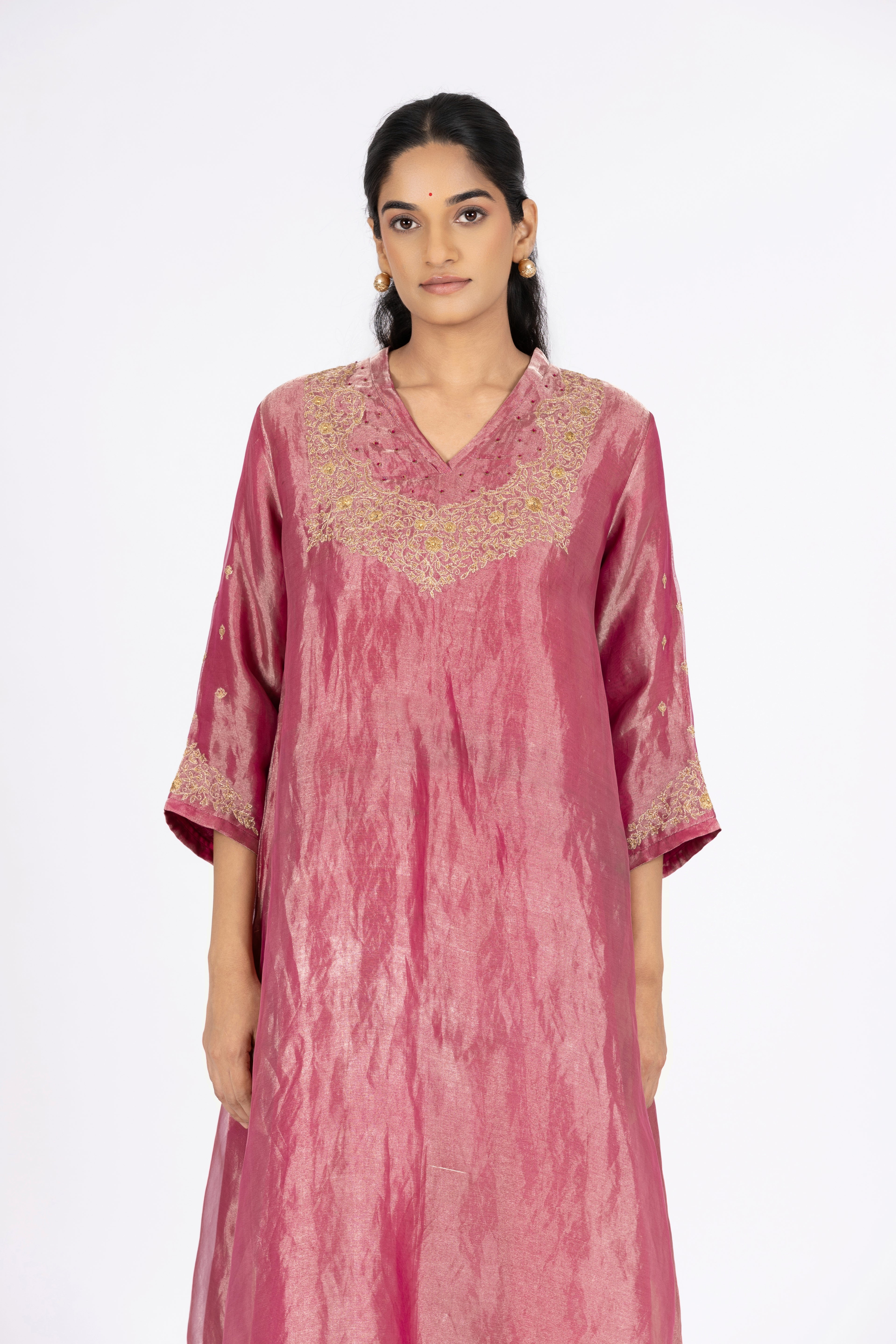 Woman wearing a Pink Tissue kurta with gold embroidery on a white background
