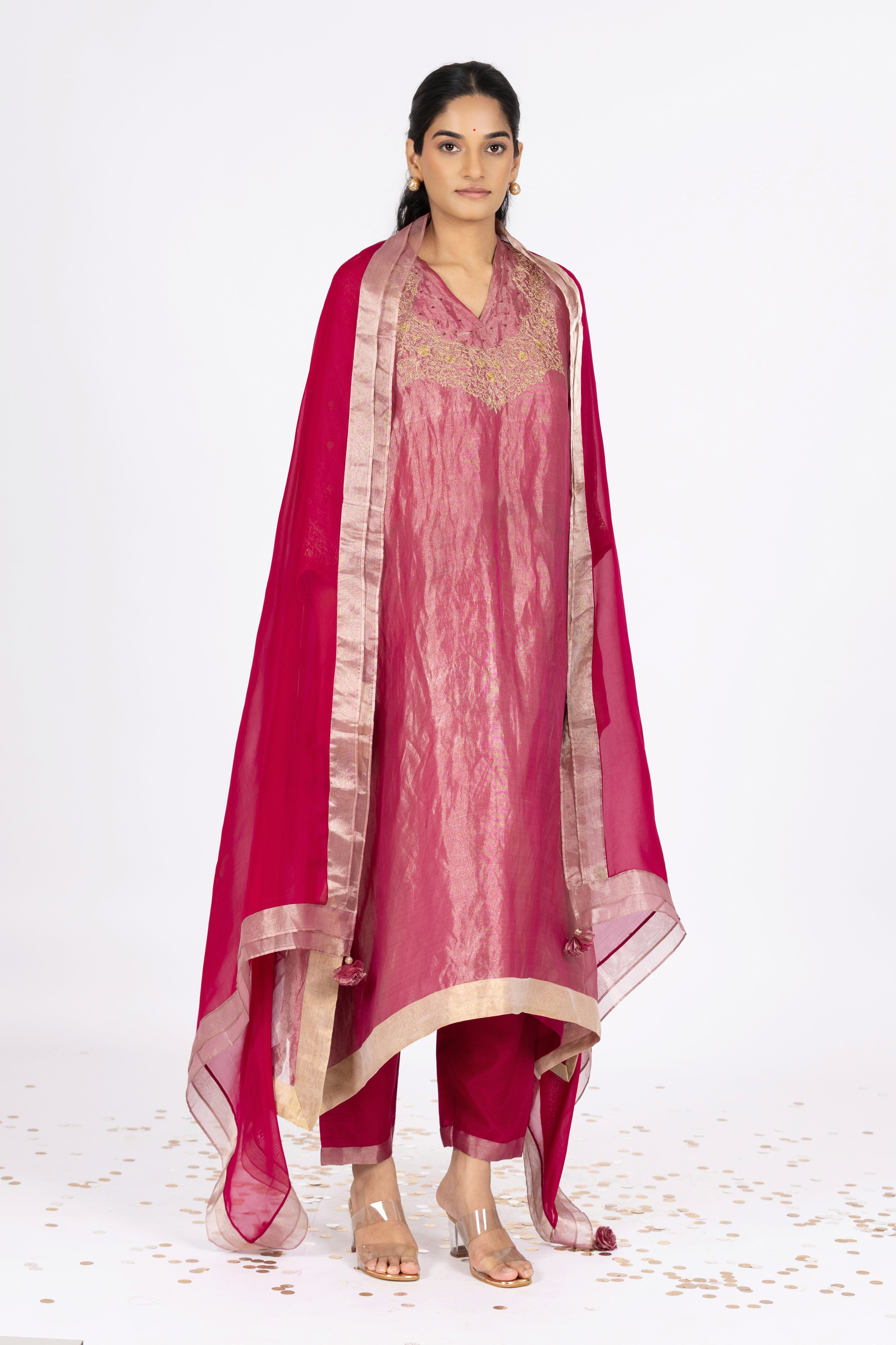 Woman wearing a Pink Tissue kurta with gold embroidery on a white background
