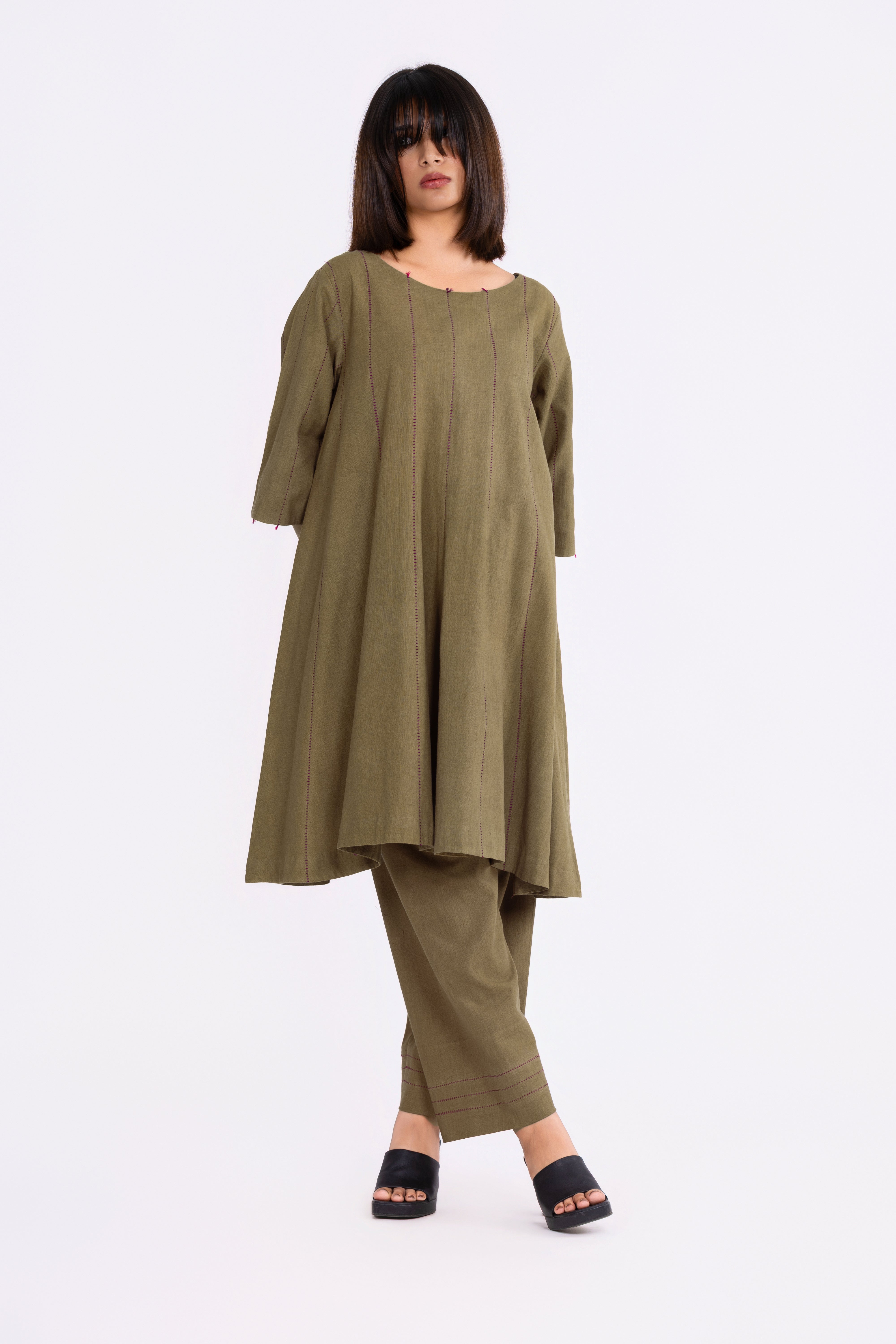 Woman wearing an olive green top and pants set