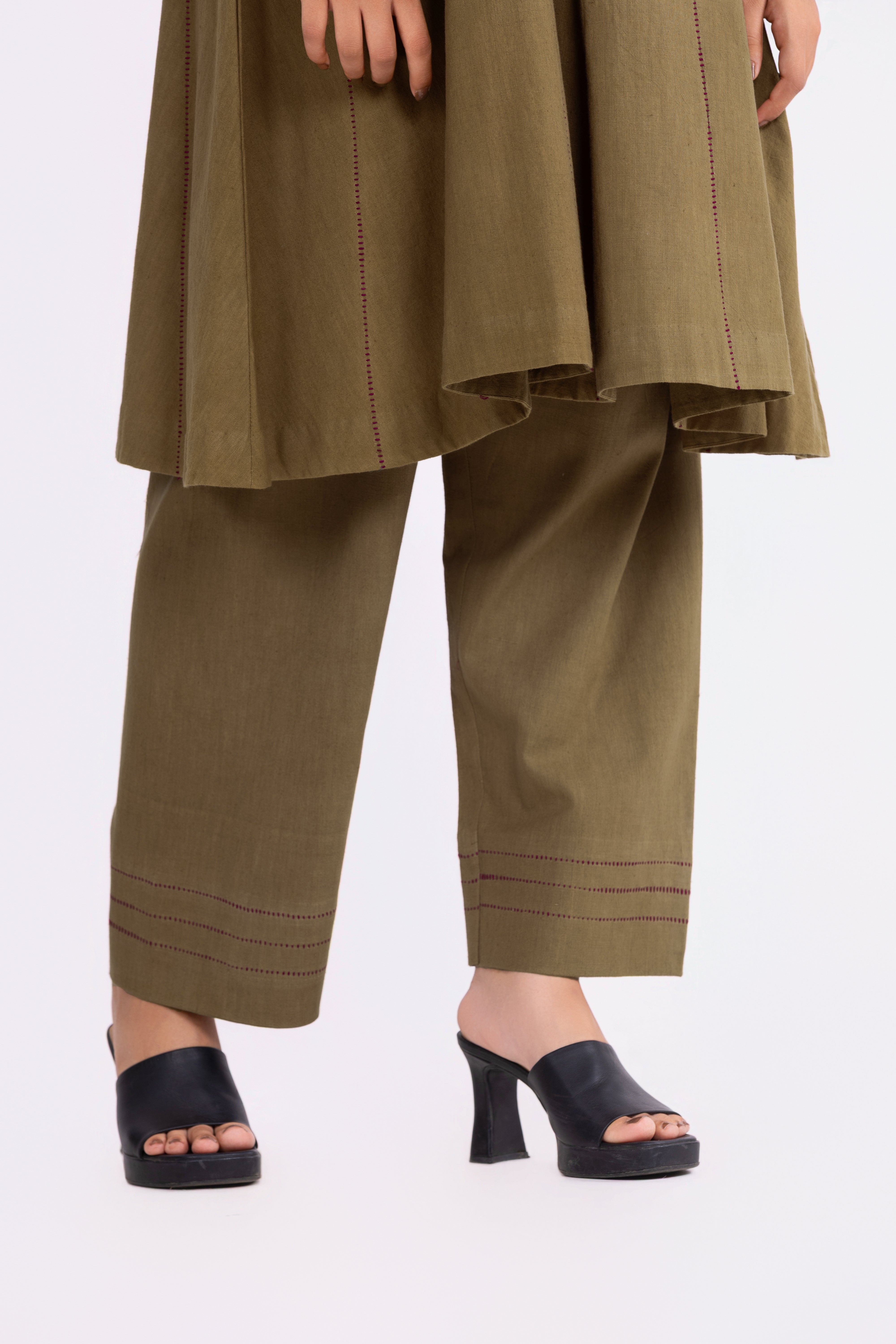 Olive green pants with a matching top on a white background