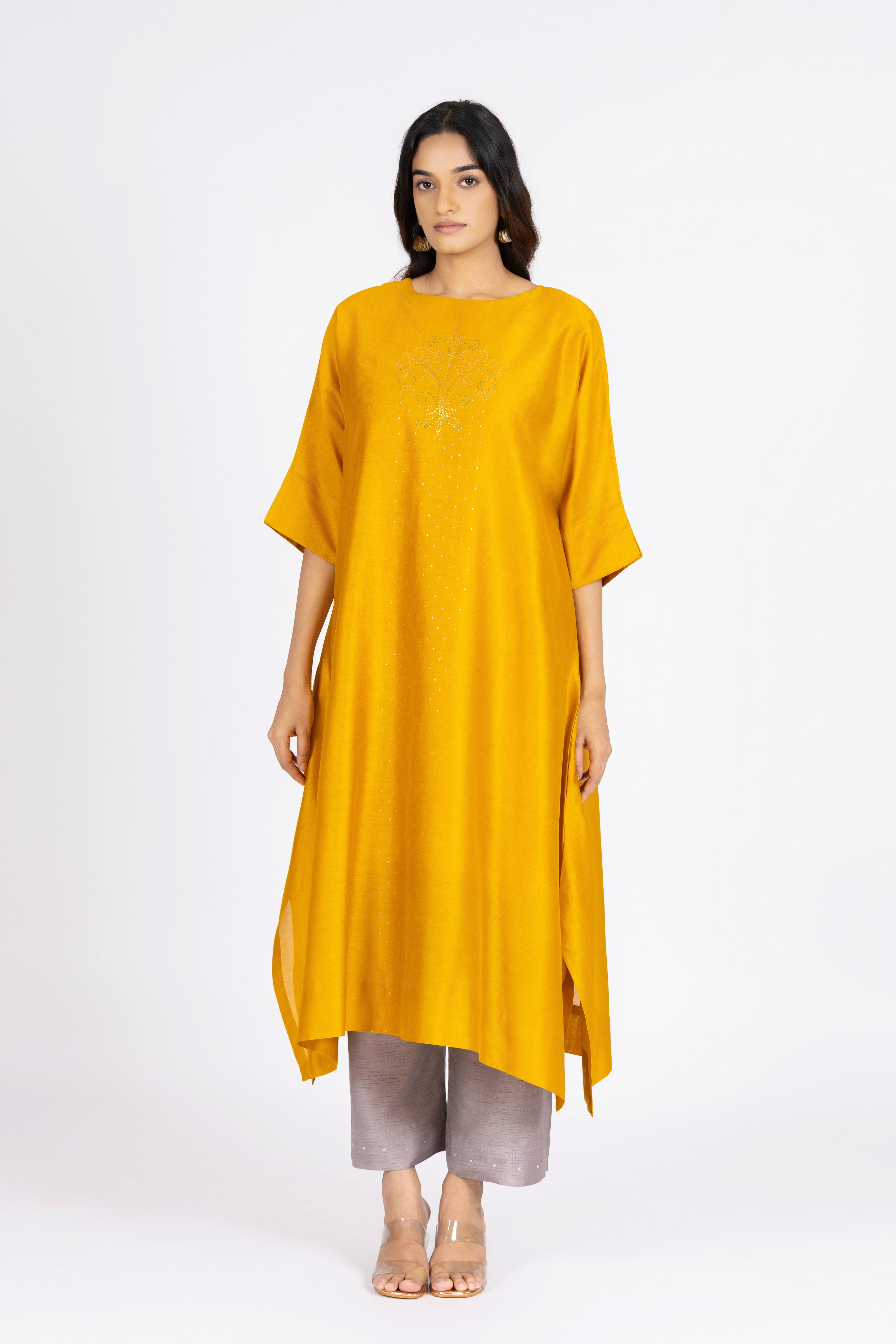 Woman wearing a yellow dress with a white background