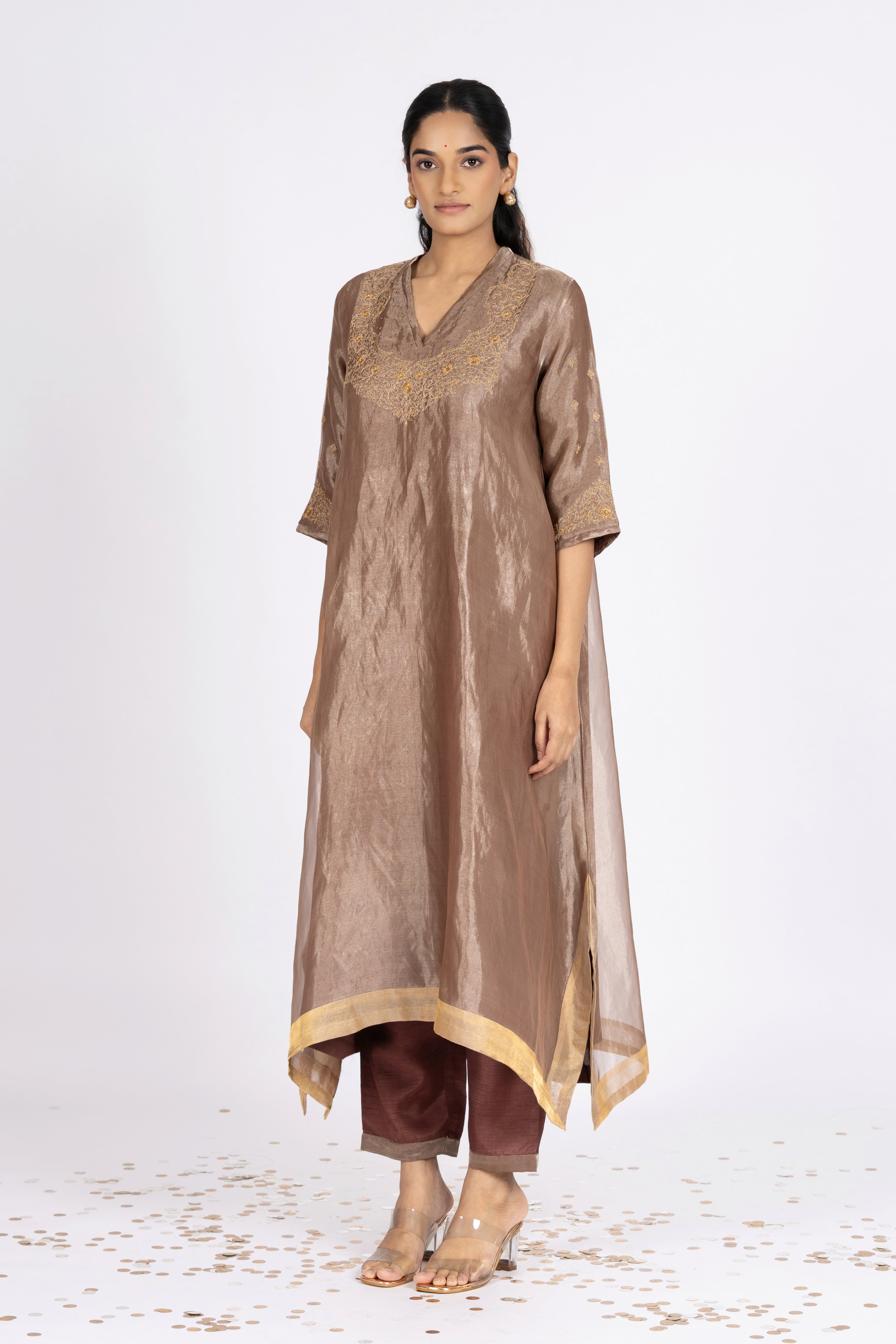 Woman wearing a Pink Tissue kurta with gold embroidery on a white background