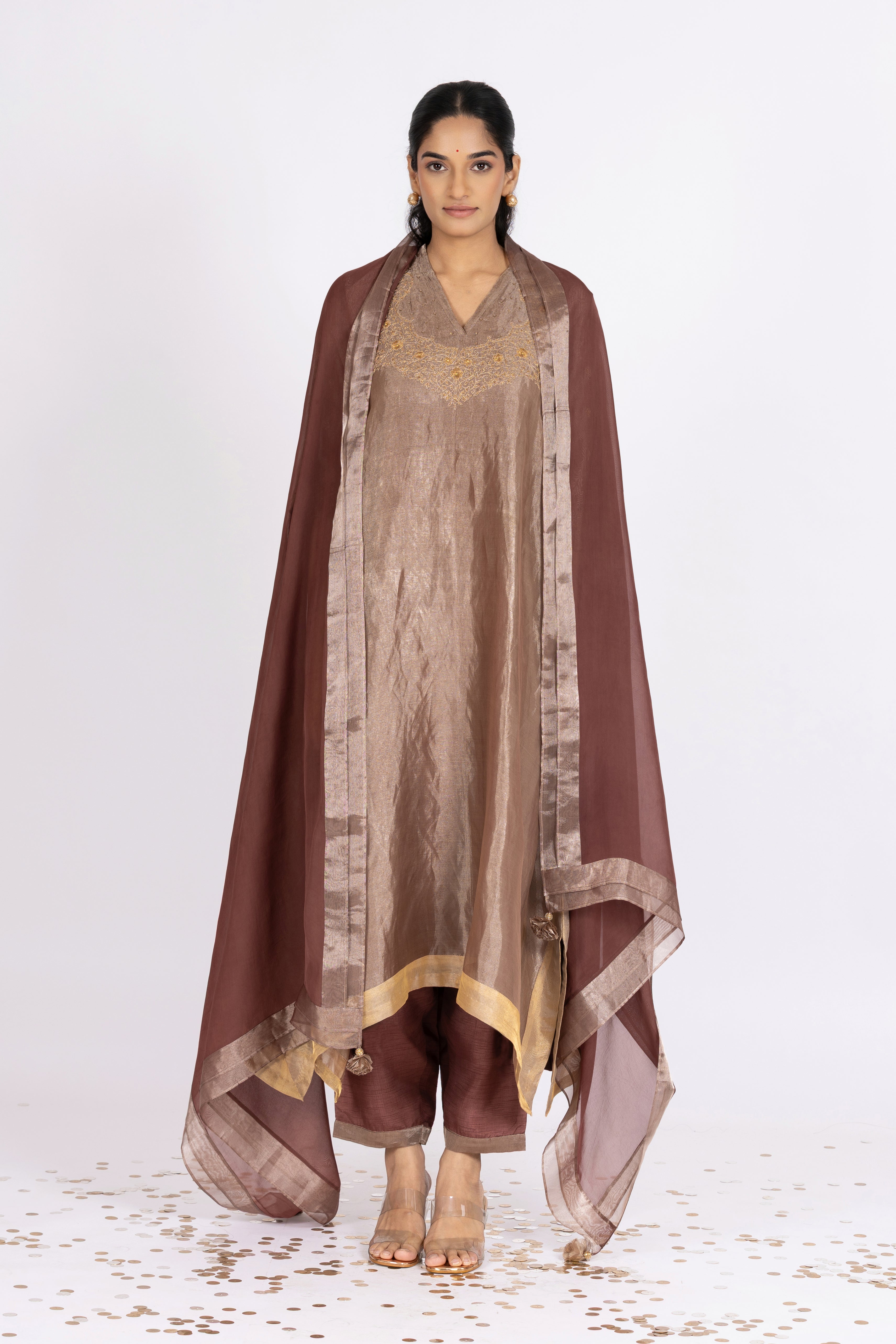 Woman wearing a Pink Tissue kurta with gold embroidery on a white background